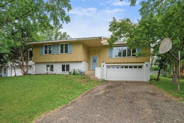 1813 Stinson Blvd, New Brighton, MN 55112 - bi-level home with a garage, driveway, and brick siding