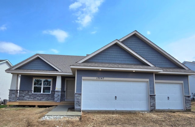 13540 Carrakay Way, Rosemount, MN 55068 - craftsman house with stone siding, an attached garage, driveway, and a shingled roof