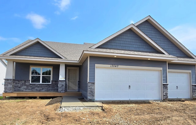 13540 Carrakay Way, Rosemount, MN 55068 - craftsman-style house with stone siding, a garage, covered porch, and a shingled roof