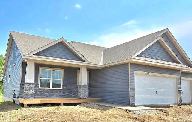 13540 Carrakay Way, Rosemount, MN 55068 - craftsman house featuring stone siding, covered porch, a garage, and a shingled roof