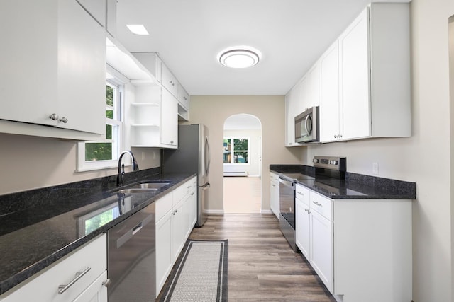 111 4th St, Kenyon, MN 55946 - kitchen with stainless steel appliances, a sink, wood finished floors, and white cabinetry