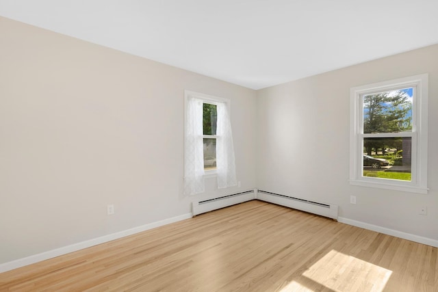 111 4th St, Kenyon, MN 55946 - spare room featuring wood finished floors, healthy amount of natural light, and baseboards