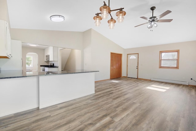 111 4th St, Kenyon, MN 55946 - kitchen featuring baseboard heating, white cabinetry, a ceiling fan, dark countertops, and stainless steel appliances