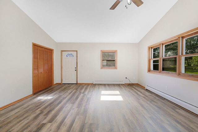 111 4th St, Kenyon, MN 55946 - spare room with a baseboard heating unit, wood finished floors, ceiling fan, baseboards, and high vaulted ceiling