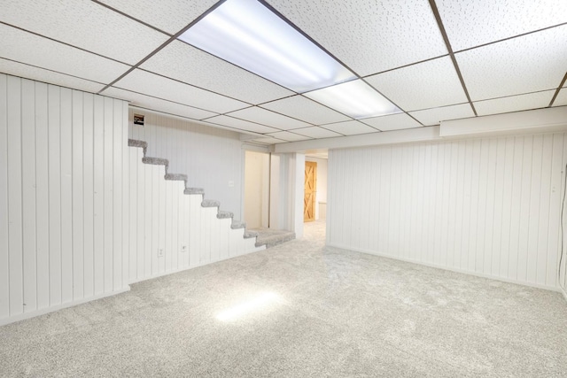 111 4th St, Kenyon, MN 55946 - finished basement featuring stairs, carpet floors, a drop ceiling, and wooden walls