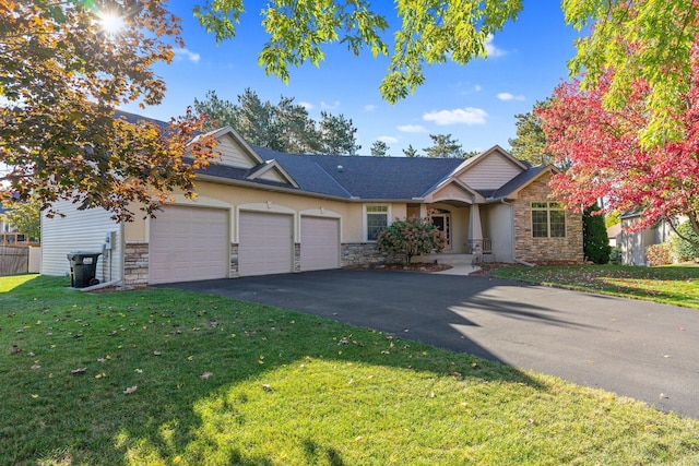 13023 Yellow Pine Cir NW, Coon Rapids, MN 55448 - view of front of house featuring stone siding, an attached garage, asphalt driveway, a front lawn, and stucco siding