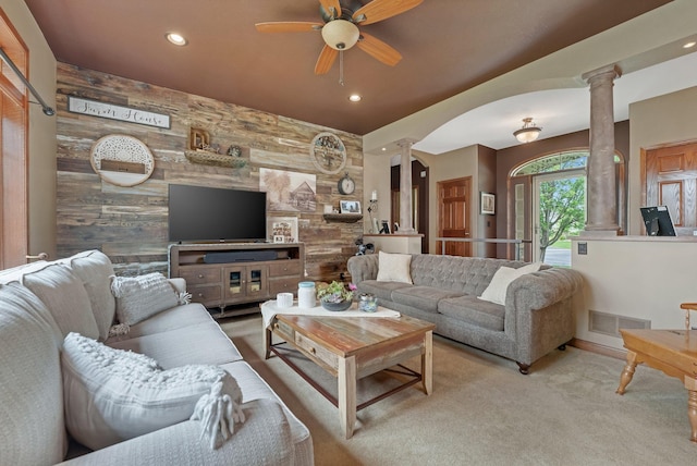 13023 Yellow Pine Cir NW, Coon Rapids, MN 55448 - living room featuring ornate columns, a ceiling fan, wood walls, recessed lighting, and arched walkways