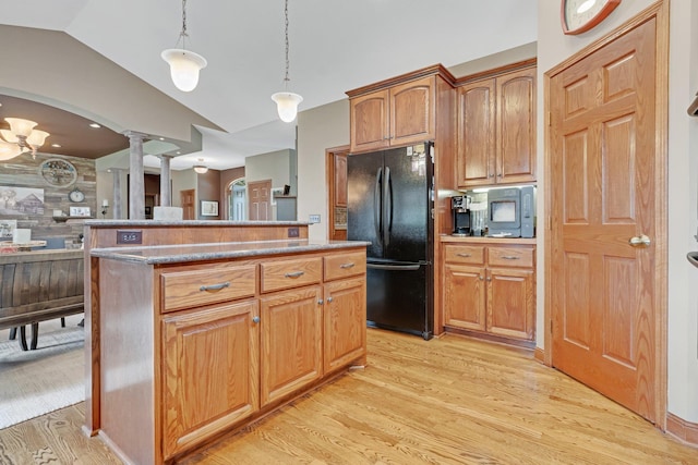 13023 Yellow Pine Cir NW, Coon Rapids, MN 55448 - kitchen featuring freestanding refrigerator, light wood-style floors, ornate columns, vaulted ceiling, and decorative light fixtures