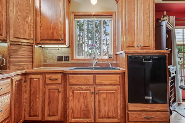 13023 Yellow Pine Cir NW, Coon Rapids, MN 55448 - kitchen featuring a sink, plenty of natural light, brown cabinetry, and decorative backsplash