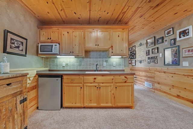 13023 Yellow Pine Cir NW, Coon Rapids, MN 55448 - kitchen with stainless steel refrigerator, white microwave, wood ceiling, light brown cabinets, and a sink