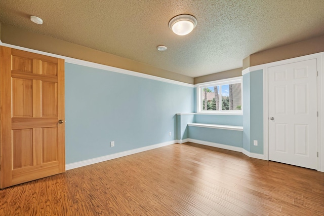 13023 Yellow Pine Cir NW, Coon Rapids, MN 55448 - unfurnished bedroom with a textured ceiling, wood finished floors, and baseboards
