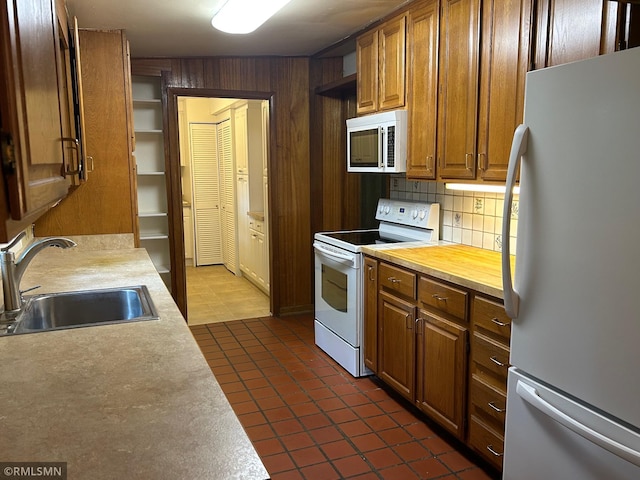 11209 Oak Ridge Ln W, Minnetonka, MN 55305 - kitchen with white appliances, light countertops, dark tile patterned floors, brown cabinets, and tasteful backsplash
