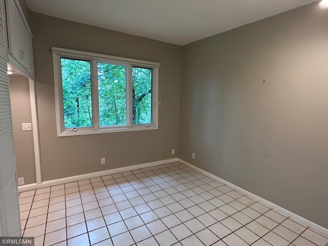 11209 Oak Ridge Ln W, Minnetonka, MN 55305 - spare room with light tile patterned floors and baseboards