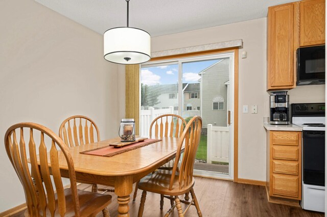 15524 Float Ln, Apple Valley, MN 55124 - dining space with dark wood-style floors and baseboards