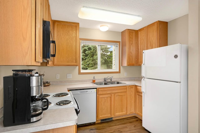 15524 Float Ln, Apple Valley, MN 55124 - kitchen with freestanding refrigerator, dishwashing machine, light countertops, a textured ceiling, and wood finished floors