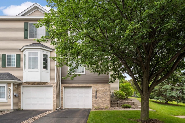 15524 Float Ln, Apple Valley, MN 55124 - view of front of home featuring driveway, an attached garage, and a front lawn
