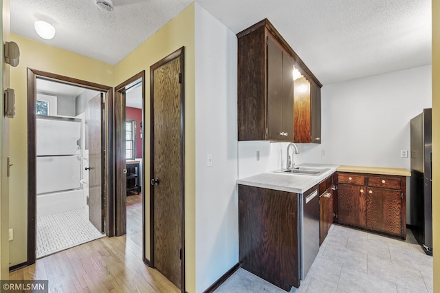6316 15th Ave S, Richfield, MN 55423 - kitchen featuring a sink, freestanding refrigerator, a textured ceiling, light countertops, and stainless steel dishwasher