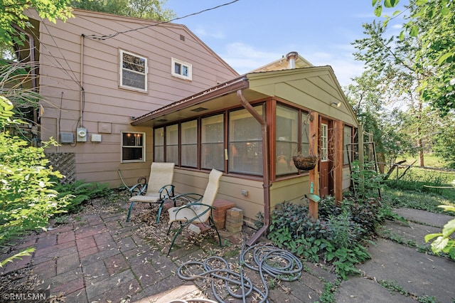 6316 15th Ave S, Richfield, MN 55423 - back of house featuring a sunroom and a patio area