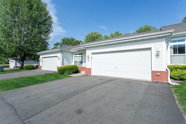 2230 Lower Afton Rd E, Saint Paul, MN 55119 - ranch-style home featuring brick siding, asphalt driveway, and a garage