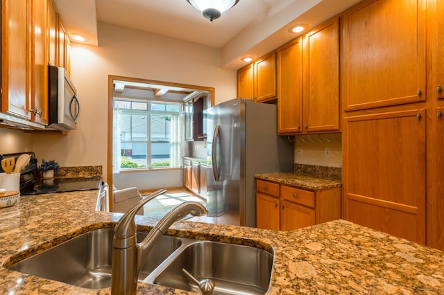2230 Lower Afton Rd E, Saint Paul, MN 55119 - kitchen with stainless steel appliances, a sink, brown cabinets, and light stone counters