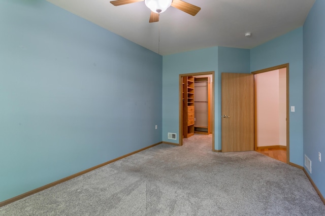 2230 Lower Afton Rd E, Saint Paul, MN 55119 - unfurnished bedroom with carpet flooring, a walk in closet, a closet, and baseboards