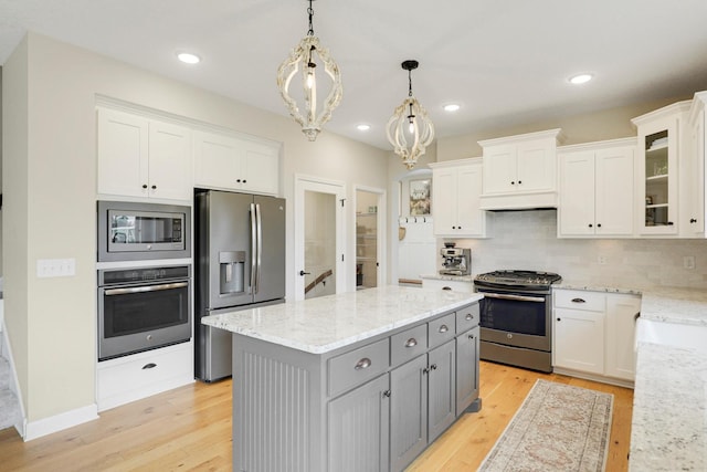 8633 Ambergate Dr, Victoria, MN 55386 - kitchen with appliances with stainless steel finishes, white cabinetry, gray cabinets, a center island, and recessed lighting