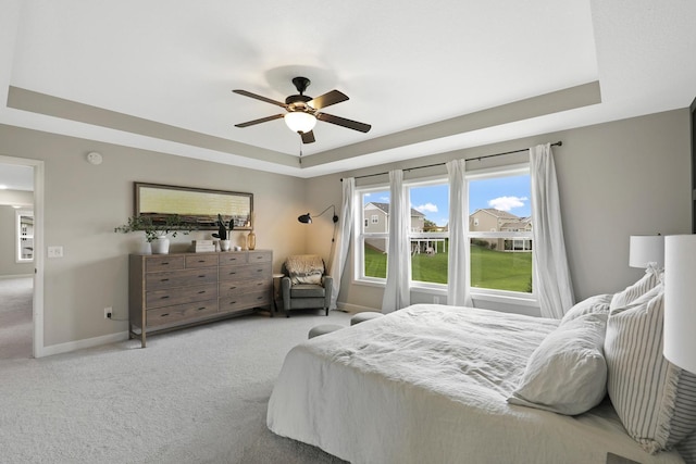 8633 Ambergate Dr, Victoria, MN 55386 - bedroom featuring a raised ceiling, carpet flooring, and a ceiling fan