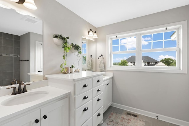 8633 Ambergate Dr, Victoria, MN 55386 - bathroom featuring two vanities and baseboards