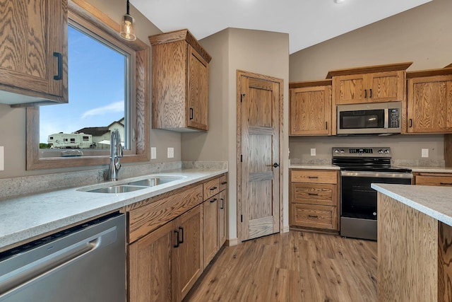 212 Woolgrass Way, Avon, MN 56310 - kitchen with stainless steel appliances, a sink, vaulted ceiling, light wood finished floors, and light countertops