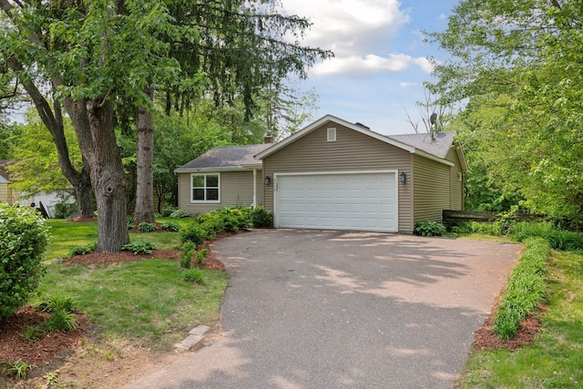 5110 Woodridge Rd, Minnetonka, MN 55345 - view of front facade with driveway, an attached garage, and a chimney