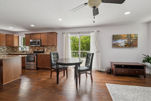 5110 Woodridge Rd, Minnetonka, MN 55345 - dining area with healthy amount of natural light, a ceiling fan, dark wood-style flooring, and recessed lighting