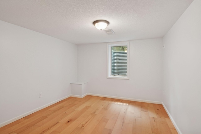 5110 Woodridge Rd, Minnetonka, MN 55345 - empty room featuring light wood-style floors, a textured ceiling, and baseboards