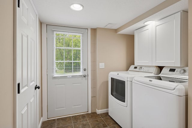 5110 Woodridge Rd, Minnetonka, MN 55345 - laundry area with separate washer and dryer, cabinet space, baseboards, and dark tile patterned flooring