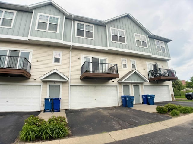 1366 Phalen Blvd, Saint Paul, MN 55106 - multi unit property featuring board and batten siding, an attached garage, a balcony, and driveway
