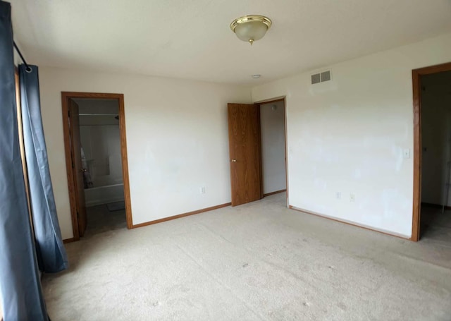 1366 Phalen Blvd, Saint Paul, MN 55106 - unfurnished bedroom featuring light carpet, baseboards, and connected bathroom