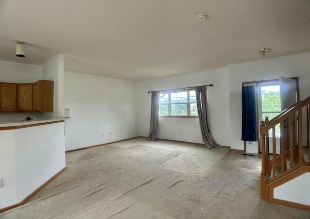 1366 Phalen Blvd, Saint Paul, MN 55106 - unfurnished living room with light carpet and stairs