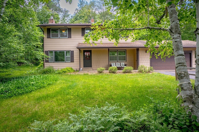 41502 Flink Ave, North Branch, MN 55056 - traditional-style home featuring a chimney, a garage, driveway, a porch, and a front yard