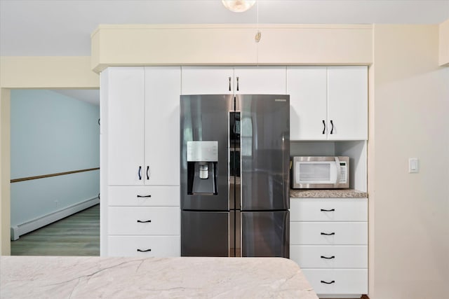 41502 Flink Ave, North Branch, MN 55056 - kitchen featuring fridge with ice dispenser, white microwave, a baseboard heating unit, wood finished floors, and white cabinetry