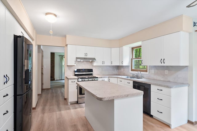 41502 Flink Ave, North Branch, MN 55056 - kitchen with black appliances, under cabinet range hood, light wood-style flooring, light countertops, and decorative backsplash