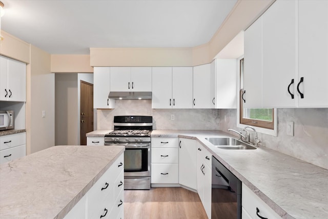 41502 Flink Ave, North Branch, MN 55056 - kitchen with gas range, dishwashing machine, under cabinet range hood, light countertops, and decorative backsplash