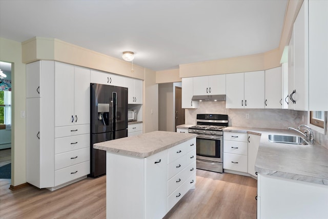 41502 Flink Ave, North Branch, MN 55056 - kitchen with gas range, black fridge with ice dispenser, light wood-type flooring, and decorative backsplash