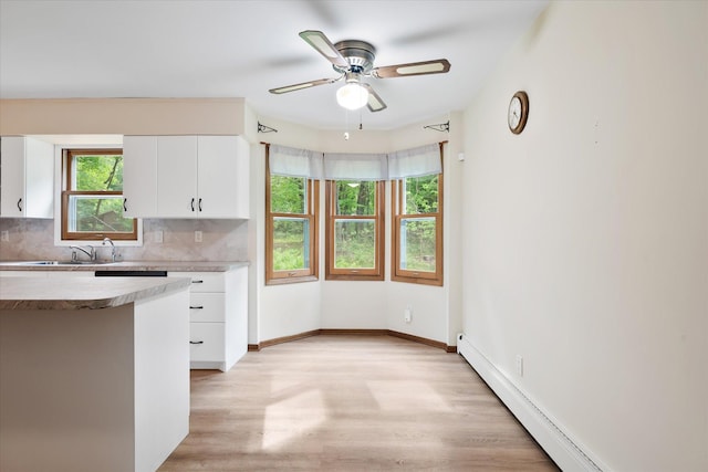 41502 Flink Ave, North Branch, MN 55056 - kitchen featuring a baseboard radiator, decorative backsplash, white cabinetry, and ceiling fan