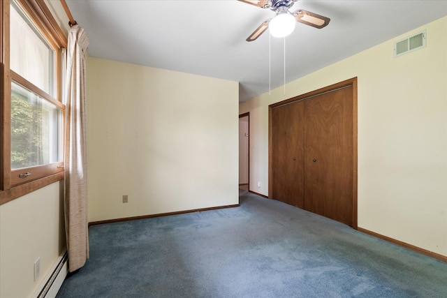 41502 Flink Ave, North Branch, MN 55056 - unfurnished bedroom with a baseboard heating unit, carpet flooring, a closet, and ceiling fan