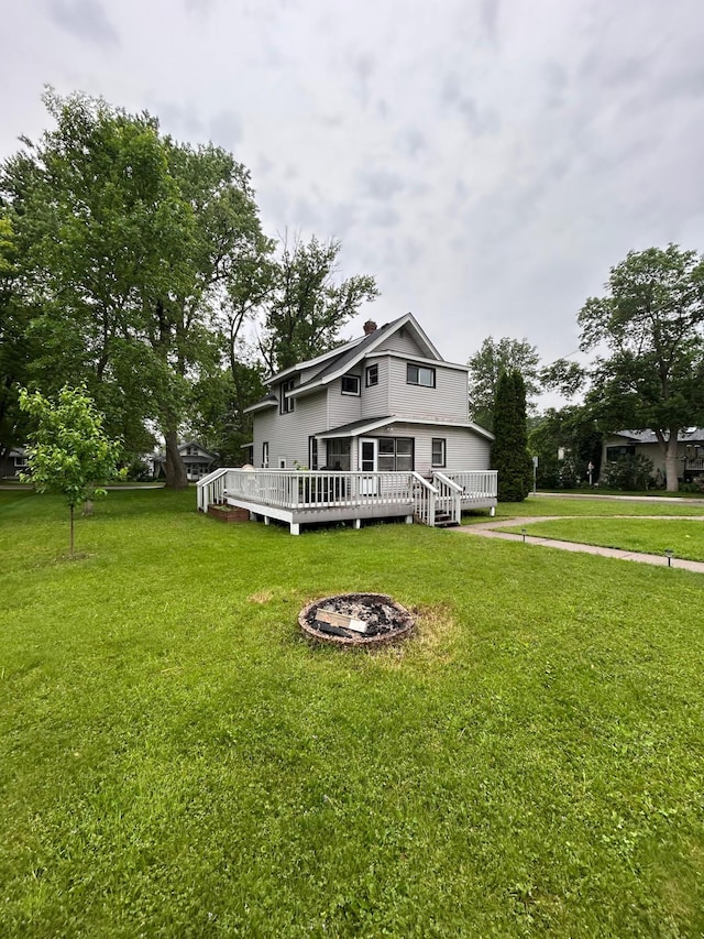 720 5th Ave N, Sauk Rapids, MN 56379 - rear view of house featuring a lawn and a deck