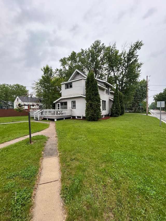720 5th Ave N, Sauk Rapids, MN 56379 - view of front of home featuring a wooden deck and a front yard