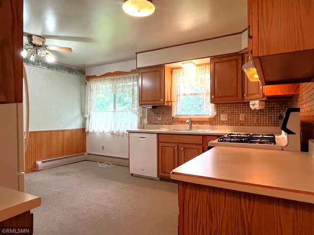 1277 Shakopee Ave E, Shakopee, MN 55379 - kitchen with white dishwasher, a sink, light countertops, tasteful backsplash, and wainscoting