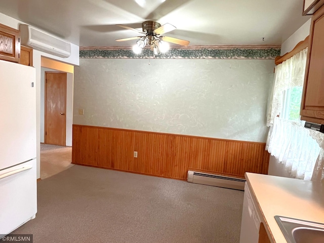 1277 Shakopee Ave E, Shakopee, MN 55379 - unfurnished dining area with a wall mounted AC, baseboard heating, wooden walls, a wainscoted wall, and ceiling fan