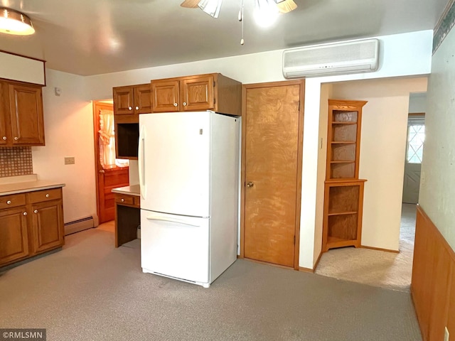 1277 Shakopee Ave E, Shakopee, MN 55379 - kitchen with freestanding refrigerator, a wall mounted AC, light carpet, and brown cabinetry