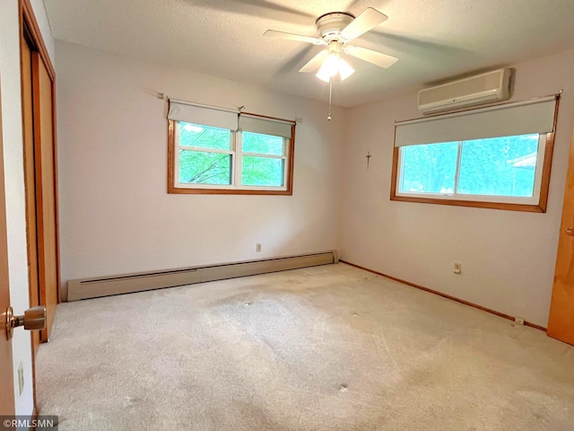 1277 Shakopee Ave E, Shakopee, MN 55379 - unfurnished bedroom featuring a baseboard heating unit, an AC wall unit, carpet, a closet, and baseboards