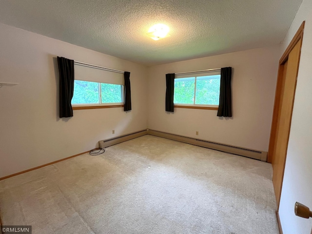 1277 Shakopee Ave E, Shakopee, MN 55379 - unfurnished bedroom with a textured ceiling, carpet, baseboards, and a baseboard heating unit